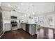 Bright kitchen with stainless steel appliances, granite countertops, a central island, and dark wood floors at 136 Kingston Dr, Locust, NC 28097