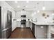 Modern kitchen with stainless steel appliances, white cabinets, granite countertops and hardwood floors at 136 Kingston Dr, Locust, NC 28097