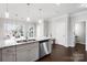 Modern kitchen featuring granite countertops, stainless steel appliances, an island with a sink, and dark wood floors at 136 Kingston Dr, Locust, NC 28097
