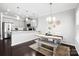 Open concept kitchen and dining area with white cabinets, granite countertops, and hardwood floors at 136 Kingston Dr, Locust, NC 28097