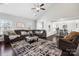 Spacious living room featuring a vaulted ceiling, stylish decor, a plush sofa, and dark wood flooring at 136 Kingston Dr, Locust, NC 28097