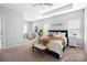 Serene main bedroom with tray ceilings, neutral tones, ample natural light, and comfortable furnishings at 136 Kingston Dr, Locust, NC 28097