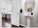 Charming powder room features pedestal sink and open doorway to kitchen at 136 Kingston Dr, Locust, NC 28097