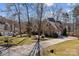 Sprawling home showing a long driveway, attached garage, and large lot with mature trees, offering privacy at 170 Anniston Way, Davidson, NC 28036