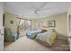 The bedroom includes two twin beds, a ceiling fan, neutral carpet and walls, and natural light from a window at 170 Anniston Way, Davidson, NC 28036