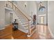 Elegant foyer with chandelier, hardwood floors, staircase, and a view of the front door with decorative glass at 170 Anniston Way, Davidson, NC 28036