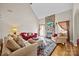 Bright living room featuring a stone fireplace, hardwood floors, and comfortable seating arrangement at 170 Anniston Way, Davidson, NC 28036