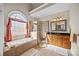 This main bathroom includes a soaking tub, glass enclosed shower, tiled floors and walls, and a double vanity sink at 170 Anniston Way, Davidson, NC 28036