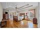 The main bedroom boasts a tray ceiling, hardwood floors, and large windows, with a sitting area in the background at 170 Anniston Way, Davidson, NC 28036