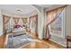 Bright sitting area features hardwood floors, a comfortable chaise lounge, and lots of natural light from the surrounding windows at 170 Anniston Way, Davidson, NC 28036