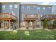Multi-story townhomes featuring elevated decks overlooking the lush green backyard at 1932 Catkin Ln, Charlotte, NC 28205
