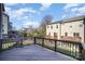 Backyard view showing an elevated deck and multi-story townhomes under a sunny sky at 1932 Catkin Ln, Charlotte, NC 28205