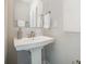 Modern pedestal sink in a well-lit bathroom with clean lines and neutral colors at 1932 Catkin Ln, Charlotte, NC 28205