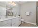 Beautiful bathroom with double sinks, white cabinets, and a large mirror above the vanity at 1932 Catkin Ln, Charlotte, NC 28205