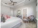 Well-lit bedroom with stylish decor, a seating area, and access to an ensuite bathroom at 1932 Catkin Ln, Charlotte, NC 28205