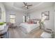 Elegant primary bedroom with tray ceilings, a seating area, and large windows at 1932 Catkin Ln, Charlotte, NC 28205
