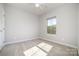 Neutral bedroom with cozy carpet, large window, and ceiling fan at 1932 Catkin Ln, Charlotte, NC 28205