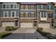 Charming townhome featuring a stone facade, three stories, and a one car garage at 1932 Catkin Ln, Charlotte, NC 28205