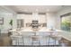 Bright, modern kitchen features white cabinetry, stainless appliances, and spacious island with seating at 1932 Catkin Ln, Charlotte, NC 28205