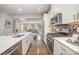 Spacious open-concept kitchen with stainless steel appliances and hardwood floors flowing into the living area at 1932 Catkin Ln, Charlotte, NC 28205