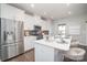 Stylish kitchen boasts stainless steel appliances, white cabinets, mosaic backsplash, and center island at 1932 Catkin Ln, Charlotte, NC 28205