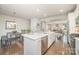 Open-concept kitchen with white cabinetry, center island, stainless steel appliances, and hardwood floors at 1932 Catkin Ln, Charlotte, NC 28205