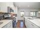 Modern kitchen features white cabinetry, stainless appliances, tile backsplash, and hardwood floors at 1932 Catkin Ln, Charlotte, NC 28205