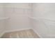 View of walk-in closet featuring white walls, carpeted floors and wire shelving throughout at 1932 Catkin Ln, Charlotte, NC 28205