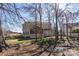 A picturesque backyard view with mature trees and a screened-in porch visible at 2010 Hollyhedge Ln, Indian Trail, NC 28079