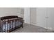 Neutral Bedroom with crib, gray carpet, white doors, and fresh paint at 2010 Hollyhedge Ln, Indian Trail, NC 28079