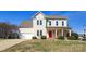 Charming two-story home features a welcoming front porch, bright red door, and a well-manicured lawn at 2010 Hollyhedge Ln, Indian Trail, NC 28079