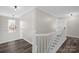 Upstairs landing with hardwood floors and white wood banister at 2010 Hollyhedge Ln, Indian Trail, NC 28079