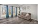 Bright living room featuring large windows with blue curtains and hardwood floors at 2010 Hollyhedge Ln, Indian Trail, NC 28079