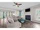 Spacious living room boasts a cozy fireplace, plush sectional sofa, ceiling fan and ample natural light at 2010 Hollyhedge Ln, Indian Trail, NC 28079