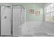 Main bathroom featuring a glass shower enclosure and soaking tub at 2010 Hollyhedge Ln, Indian Trail, NC 28079