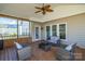Cozy screened in porch with outdoor furniture and a ceiling fan at 2010 Hollyhedge Ln, Indian Trail, NC 28079