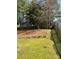 The backyard features mature trees, a wooden fence and rock border at 2017 Bridleside Dr, Indian Trail, NC 28079