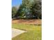 Enjoy the outdoors in this backyard with mature trees, and a pine straw bed with rock border at 2017 Bridleside Dr, Indian Trail, NC 28079