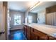 Bathroom featuring a double sink vanity, a large mirror, and neutral paint at 2017 Bridleside Dr, Indian Trail, NC 28079