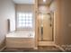 Bathroom featuring a tub, separate shower, and tile floors at 2017 Bridleside Dr, Indian Trail, NC 28079