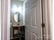 Charming powder room with a decorative mirror, a pedestal sink, and granite countertops at 2017 Bridleside Dr, Indian Trail, NC 28079