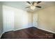 Bright bedroom features hardwood floors, a ceiling fan, and neutral color scheme at 2017 Bridleside Dr, Indian Trail, NC 28079