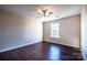 Bright, hardwood floored bedroom with natural light from the window and ceiling fan at 2017 Bridleside Dr, Indian Trail, NC 28079