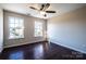 Bright bedroom with hardwood floors, a ceiling fan and natural light from two windows at 2017 Bridleside Dr, Indian Trail, NC 28079