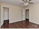 Bedroom with hardwood floors, ceiling fan, and dual closets at 2017 Bridleside Dr, Indian Trail, NC 28079