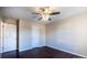 A bedroom featuring hardwood floors, a ceiling fan, and two closets at 2017 Bridleside Dr, Indian Trail, NC 28079