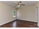 Bedroom with hardwood floors, ceiling fan, and a backyard view at 2017 Bridleside Dr, Indian Trail, NC 28079