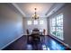 Well-lit dining room with a large window, chandelier, and seating for four at 2017 Bridleside Dr, Indian Trail, NC 28079