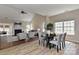 Open-concept living and dining area with modern lighting, elegant furnishings, and large windows at 2017 Bridleside Dr, Indian Trail, NC 28079