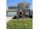 Well-manicured lawn highlights the home's exterior elevation with brick and traditional curb appeal at 2017 Bridleside Dr, Indian Trail, NC 28079